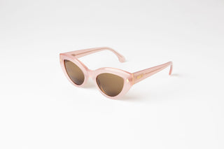 Angled view of pink Cleo Floss cateye biodegradable and sustainable sunglasses with tan lens